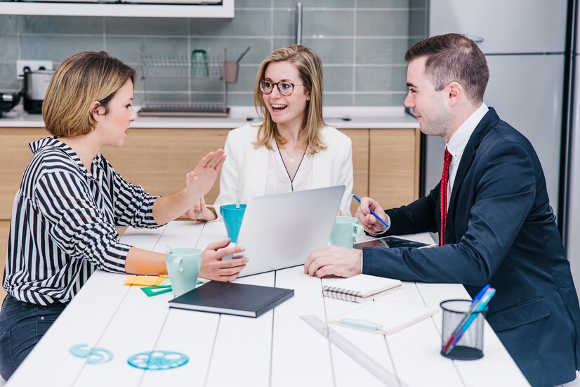Three people having a business meeting in a modern kitchen